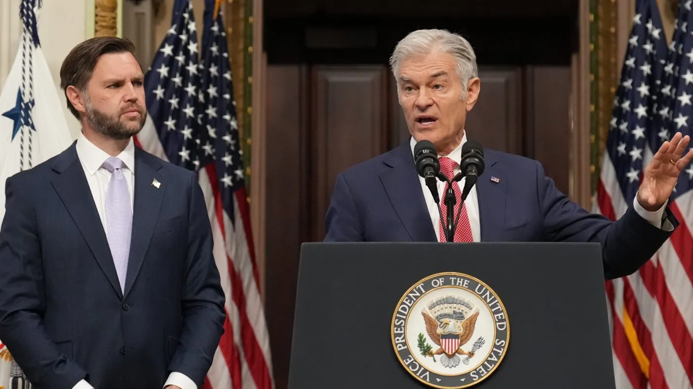 Vice President JD Vance listens as Centers for Medicare & Medicaid Services Administrator Dr. Mehmet Oz speaks to the media from the Eisenhower Executive Office Building on the White House campus, Wednesday, May 13, 2026, in Washington. (AP Photo/Jacquelyn Martin)