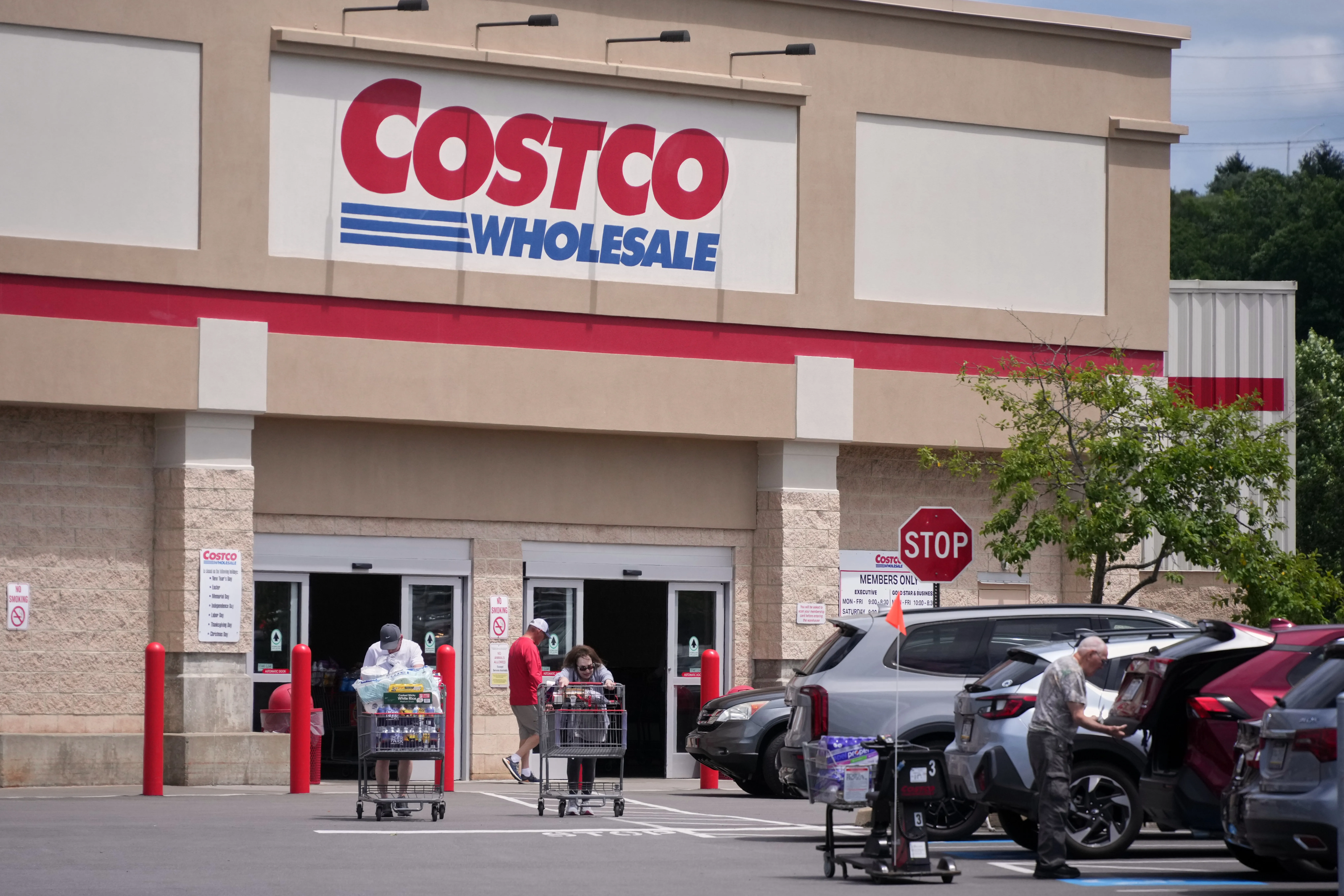 Shoppers exit a Costco Warehouse in Pittsburgh Monday, June 15, 2026. (AP Photo/Gene J. Puskar)