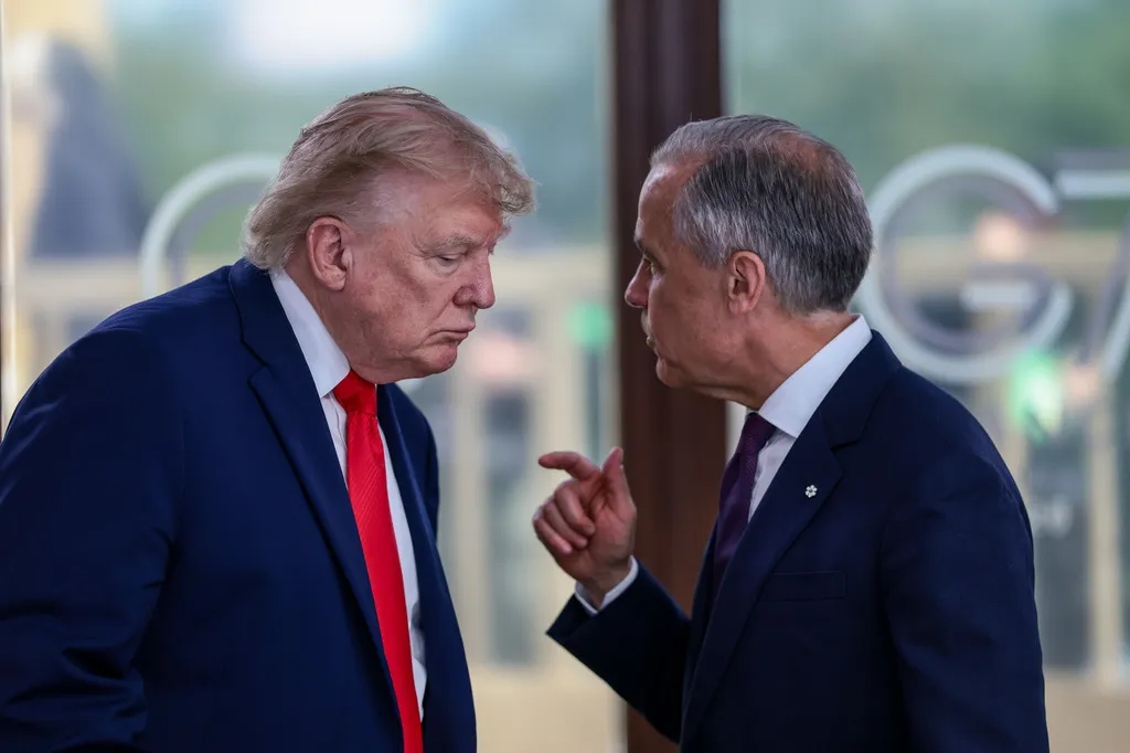 FILE – President Donald Trump speaks with Canadian Prime Minister Mark Carney, right, at a working lunch with leaders of G7 and the Middle East in Evian-les-Bains, France, Tuesday, June 16, 2026. (Evelyn Hockstein/Pool Photo via AP,File)