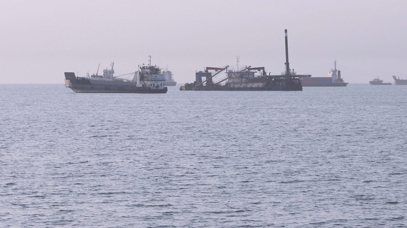 Residents swim as cargo and commercial vessels are anchored in the Strait of Hormuz off Bandar Abbas, Iran, Thursday, Aug. 6, 2026. (Amirhosein Khorgooi/ISNA via AP)