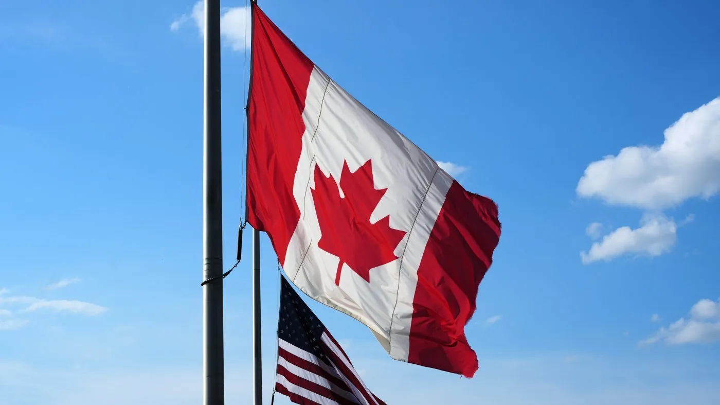 The flags of Canada, top, and the United States fly outside the Galleria Mall in Buffalo, Aug. 26, 2026.