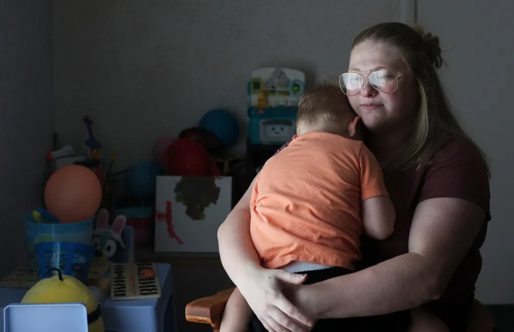Meygan Maloney poses for a portrait with her son Callum Wilson, 3, Friday, Aug. 28, 2026, at their home in Hartford City, Ind. (AP Photo/Cara Penquite)