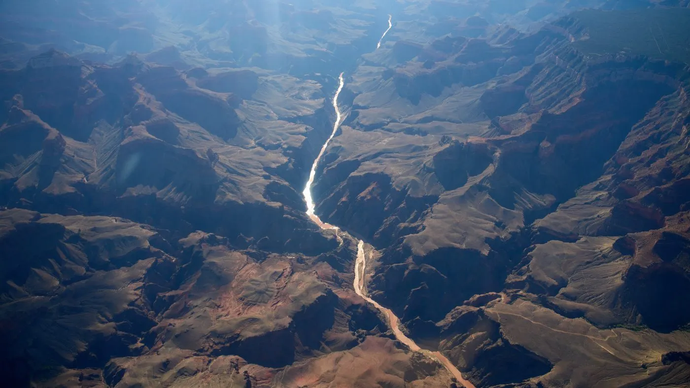 Bright Angel Canyon, middle left, the scene of flash floods, meets with the Colorado River in the Grand Canyon, Monday, Aug. 31, 2026, at Grand Canyon National Park, Ariz. (AP Photo/John Locher)