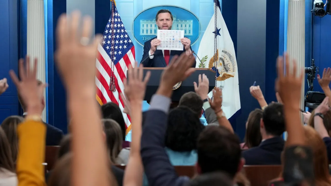 Vice President JD Vance holds up a media outlet seating chart during a press briefing at the White House in Washington, Thursday, Sept. 3, 2026. (AP Photo/Mark Schiefelbein)