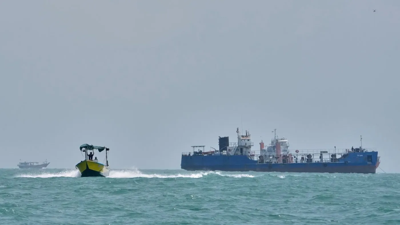 A motorboat passes a small tanker anchored in the Strait of Hormuz off Bandar Abbas, Iran, Sunday, Sept. 6, 2026. (AP Photo/Vahid Salemi)