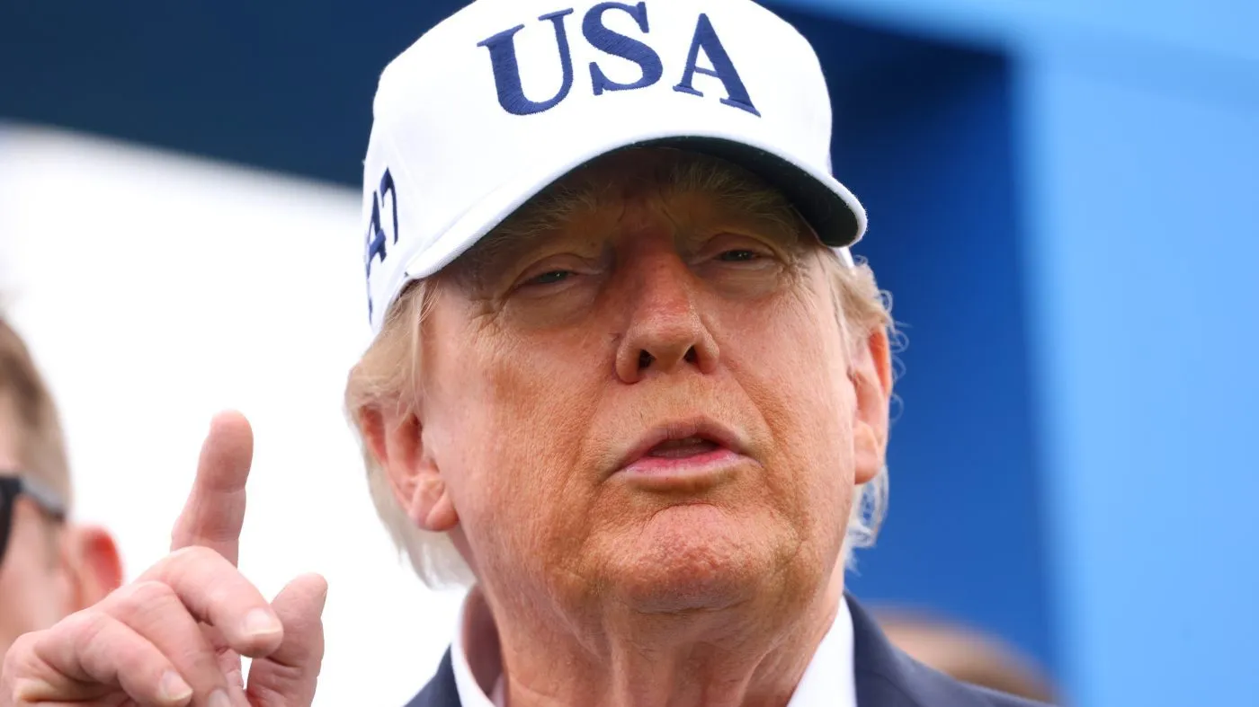 U.S. President Donald Trump speaks as he arrives at the first tee during the Irish Open at the Trump International Golf Links course in Doonbeg, Ireland, Sunday, Sept. 13, 2026.(AP Photo/Peter Morrison)
