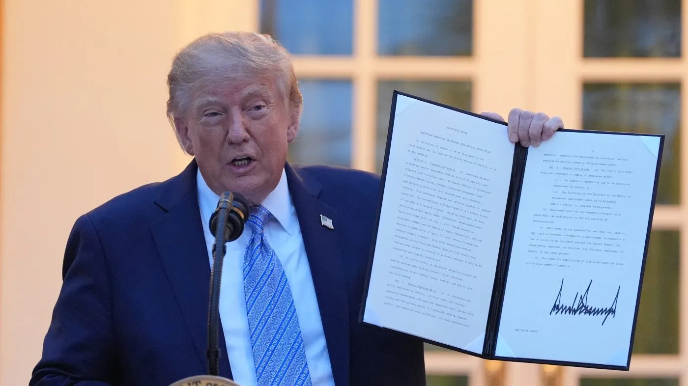 President Donald Trump displays signed orders during a dinner in the Rose Garden of the White House, Thursday, Sept. 17, 2026, in Washington. (AP Photo/Alex Brandon)