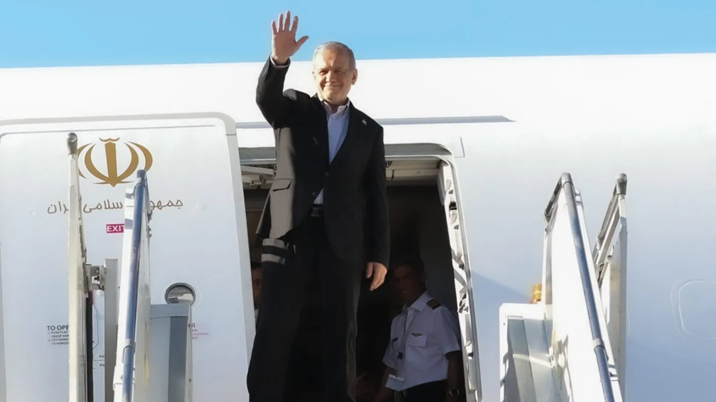 In this photo released by the Iranian Presidency Office, President Masoud Pezeshkian waves to media and officials as he boards his plane while leaving Mehrabad airport for New York to attend the UN General Assembly, in Tehran, Iran, Tuesday, Sept. 22, 2026. (Iranian Presidency Office via AP)