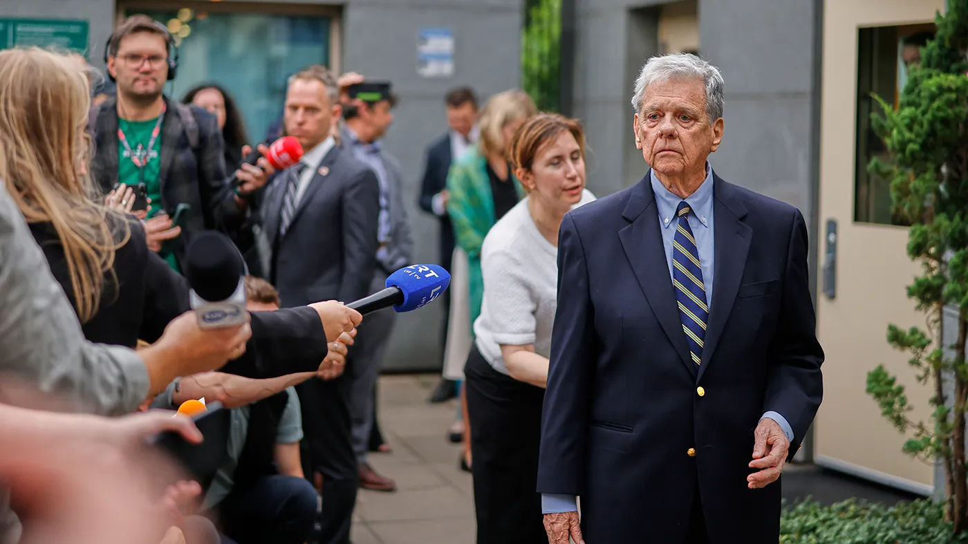 U.S. Presidential envoy John Coale, right, walks in front of journalists outside the U.S. Embassy in Vilnius, Lithuania, Thursday, Sept. 11, 2025, ahead of the arrival of released prisoners from Belarus.