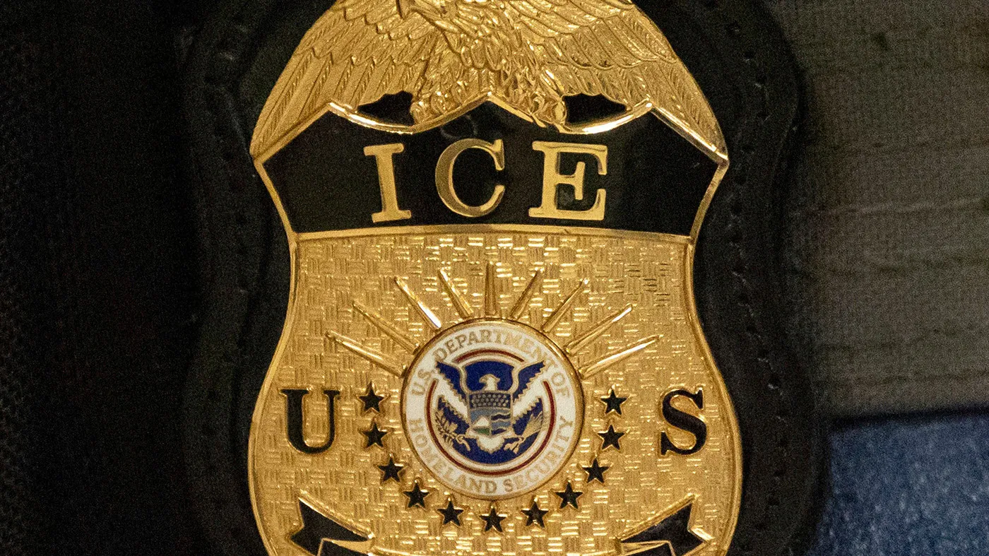 A federal officer wears an Immigration and Customs Enforcement badge in New York, June 10, 2025.