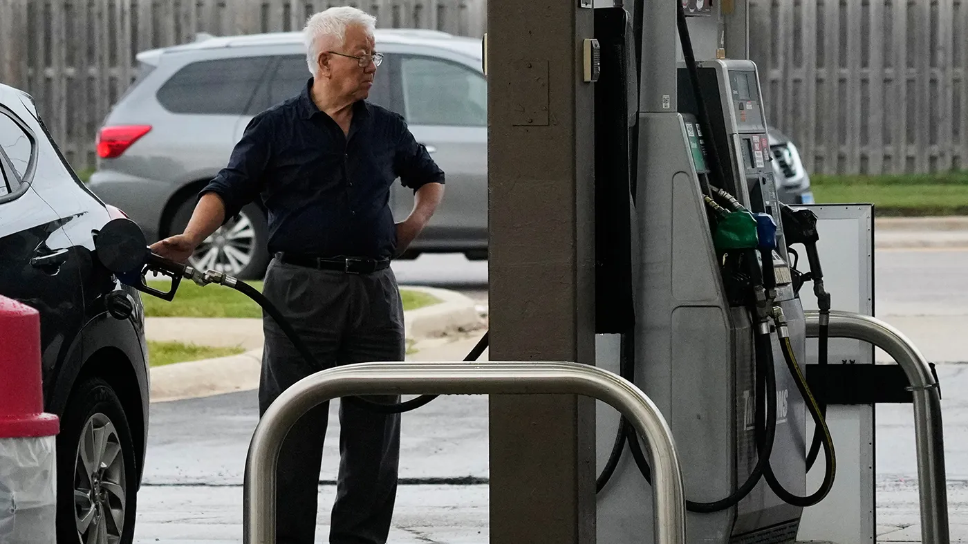 A customer checks gas price while he fills up his vehicle’s tank at a gas station, in Streamwood, Ill., Sept. 16, 2026.