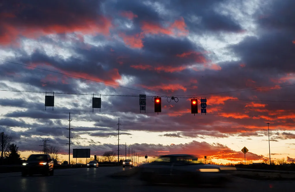 BLOOMINGTON, INDIANA – NOVEMBER 26: As drivers turn into the interstate on the eve of Thanksgiving the sunset bathes the skies in crimson on Nov. 26, 2025, in Bloomington, Indiana. (Jeremy Hogan/Getty Images)