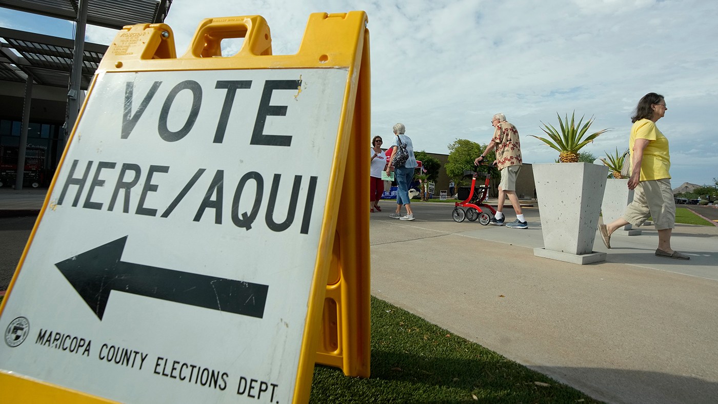 Arizona voters come and go as cast their ballots at a polling location on primary election day, July 21, 2026, in Phoenix.
