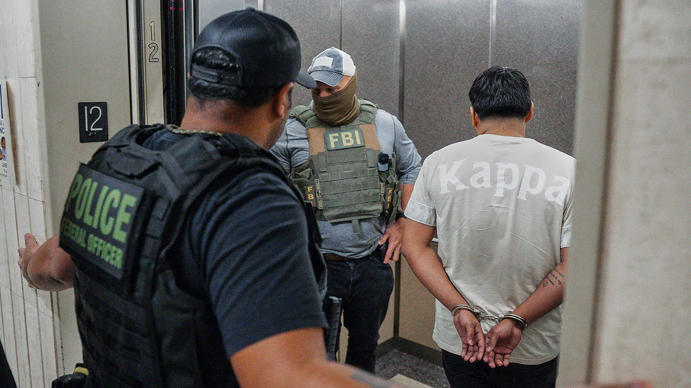 Immigration and Customs Enforcement officers escort a detained immigrant into an elevator after he exited an immigration courtroom, June 17, 2025, in New York.