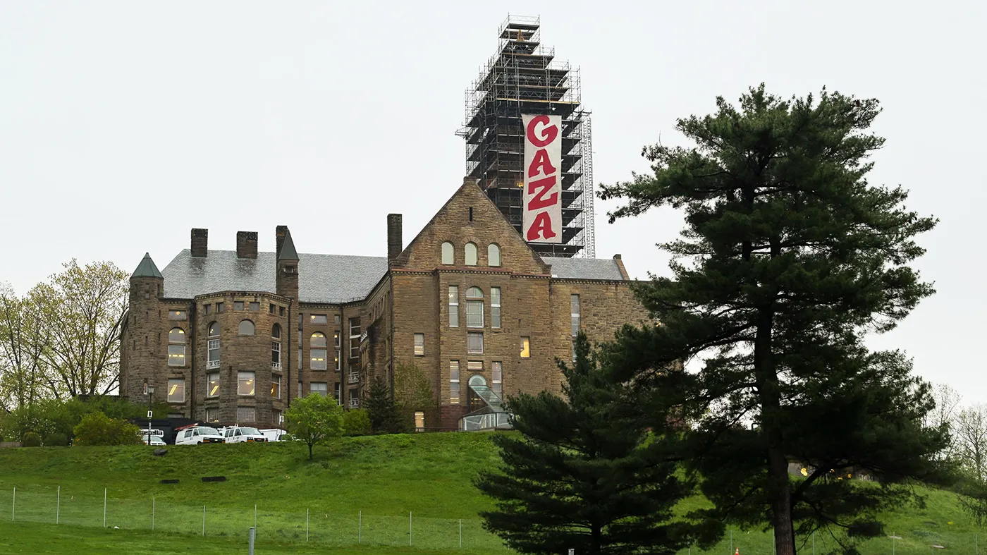 A 30-foot, pro-Palestinian banner that reads, GAZA, hangs from scaffolding on McGraw Tower at Cornell University in Ithaca, N.Y., Monday, May 5, 2025.