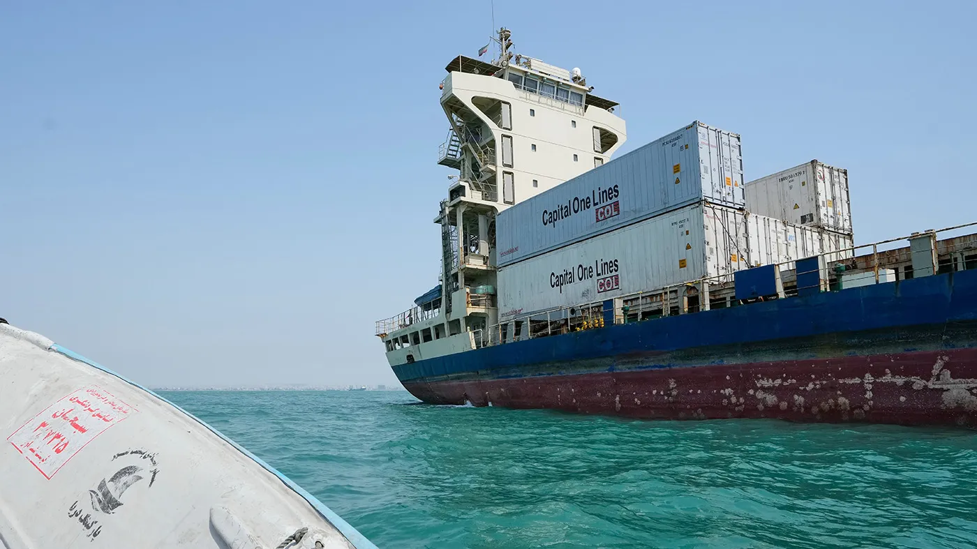 A cargo vessel carrying shipping containers lies anchored in the Strait of Hormuz off Bandar Abbas, Iran, Sept. 6, 2026.