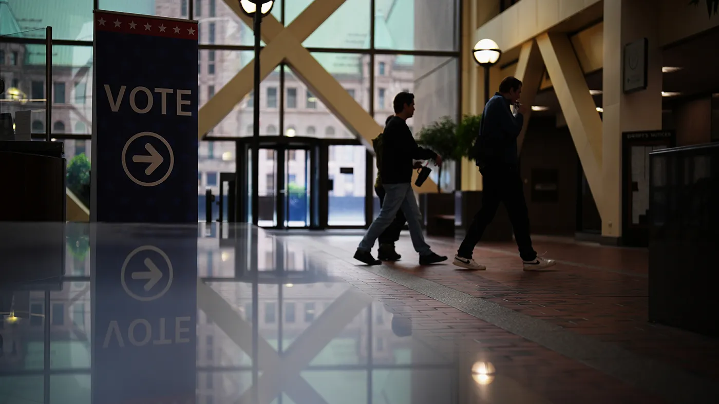People walk past a sign directing voters on the first day of early voting in Minnesota at the Elections & Voter Services building in Minneapolis, Sept. 18, 2026. (Ellen Schmidt, Asjsociated Press)