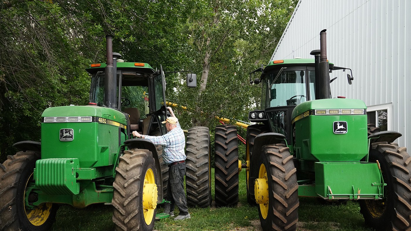 Dave Legvold climbs into a tractor at his corn and soybean farm, Aug. 26, 2026, in Northfield, Minn.