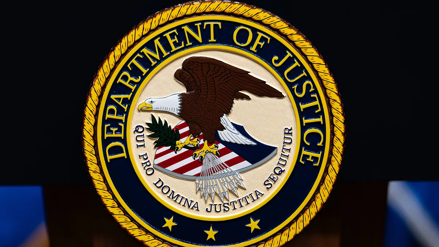 The U.S. Department of Justice logo is seen on a podium before a news conference, May 4, 2026, in Washington. (Julia Demaree Nikhinson, Associated Press)
