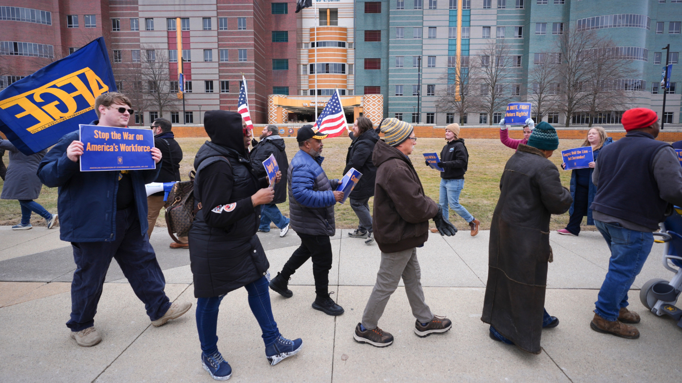 Current and former federal workers and members of the American Federation of Government Employees (AFGE) protest outside the John D. Dingell Veterans Affairs Medical Center in Detroit, Friday, Feb. 28, 2025. (AP Photo/Paul Sancya)