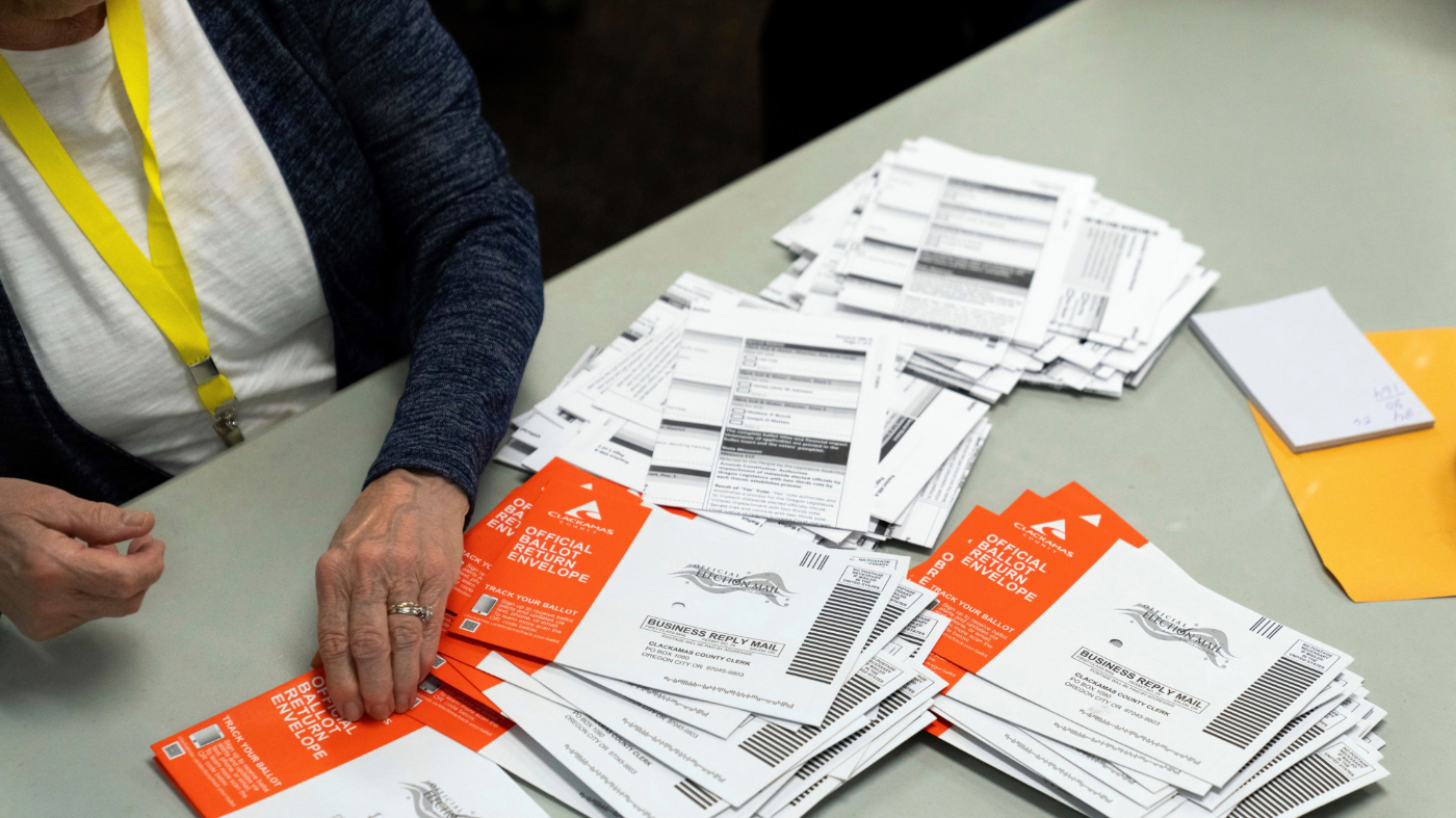 FILE – An election worker reaches for an unopened ballot during sorting at the Clackamas County Elections office, Nov. 7, 2024, in Oregon City, Ore. (AP Photo/Jenny Kane, File)