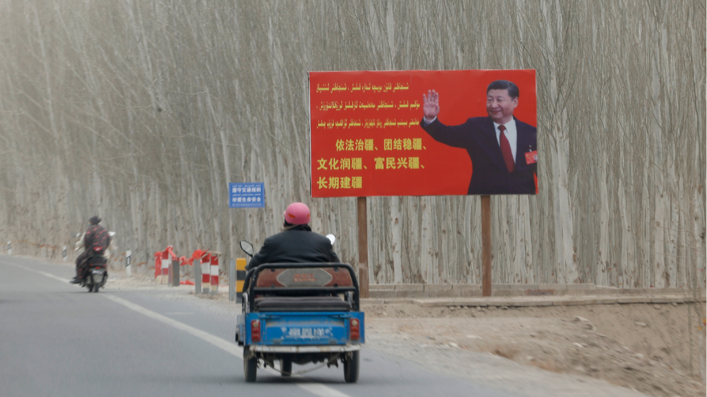 FILE – Chinese President Xi Jinping is seen on a billboard with the slogan, “Administer Xinjiang according to law, unite and stabilize the territory, culturally moisturize the territory, enrich the people and rejuvenate the territory, and build the territory for a long term,” in Yarkent County in northwestern China’s Xinjiang Uyghur Autonomous Region on March 21, 2021. Chinese characters in red reads “Building a Chinese Dream Together.” China has responded furiously to a United Nations report on alleged human rights abuses in its northwestern Xinjiang region targeting Uyghurs and other mainly Muslim ethnic minorities. (AP Photo/Ng Han Guan, File)