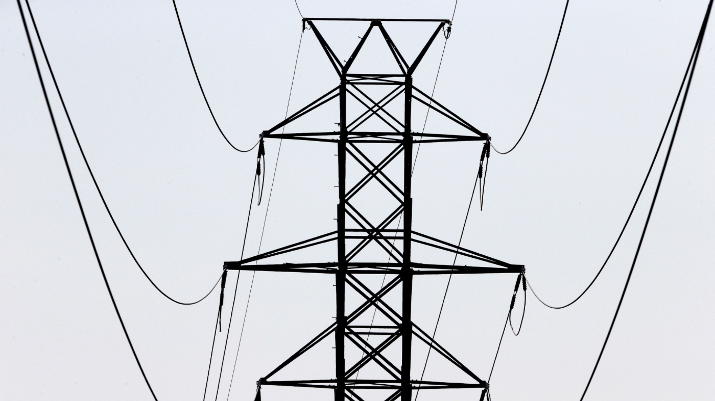 FILE- In this Aug. 14, 2018, file photo power transmission lines carry electricity along the Interstates 40 and I-85 corridor in Orange County near Hillsborough, N.C. (AP Photo/Gerry Broome, File)