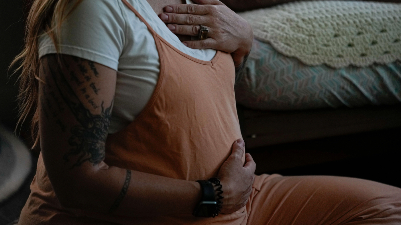 Betsy Baarspul places her hands on her heart and her belly as she shares her thoughts and feelings about her pregnancy during a prenatal group meeting at The Farm Midwifery Center, Thursday, Aug. 31, 2023, in Summertown, Tenn. (AP Photo/George Walker IV)