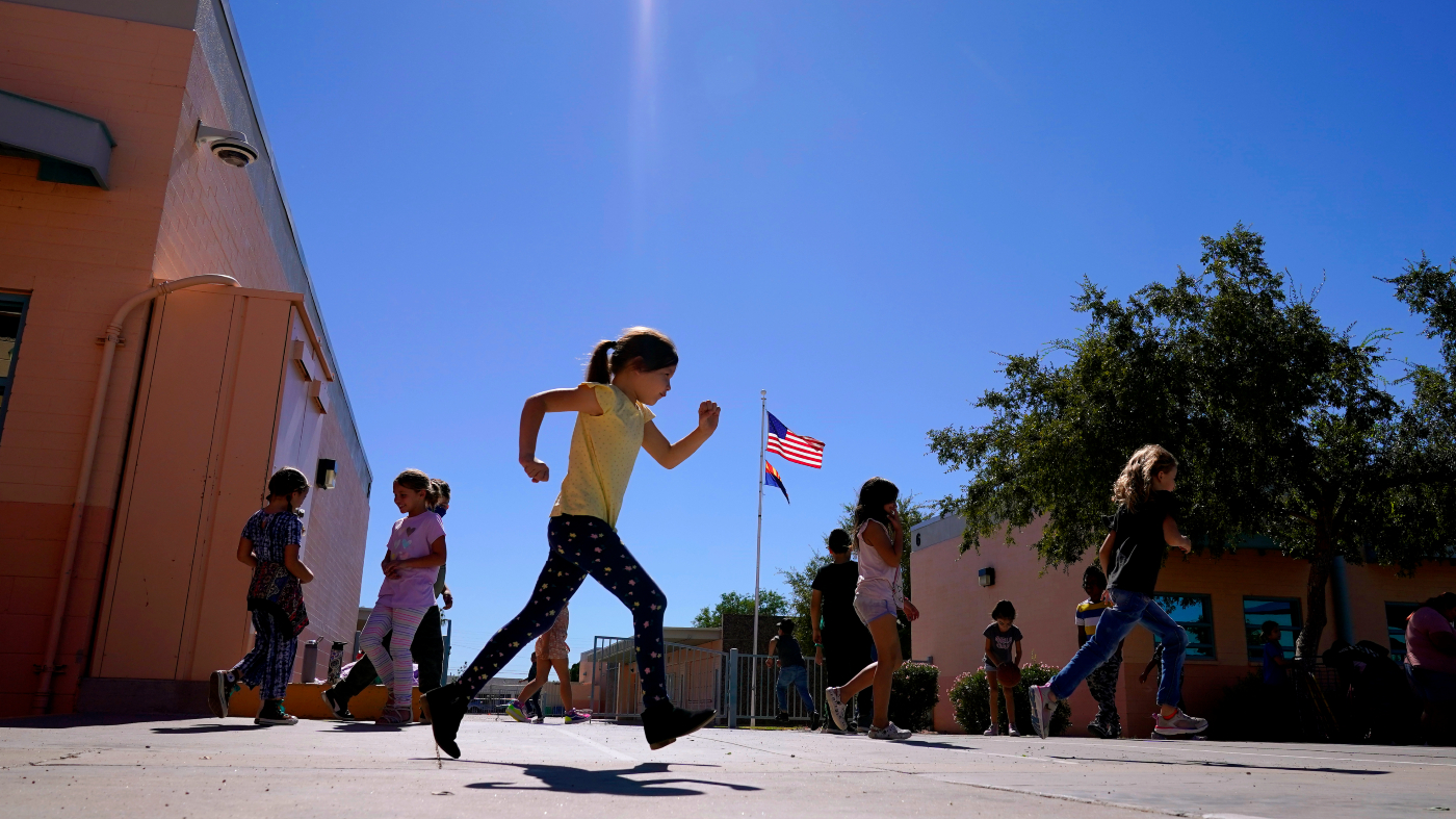 FILE – Whittier Elementary School students enjoy recess, Tuesday, Oct. 18, 2022 in Mesa, Ariz. Like many school districts across the country, Mesa has a teacher shortage due in part due to low morale and declining interest in the profession.