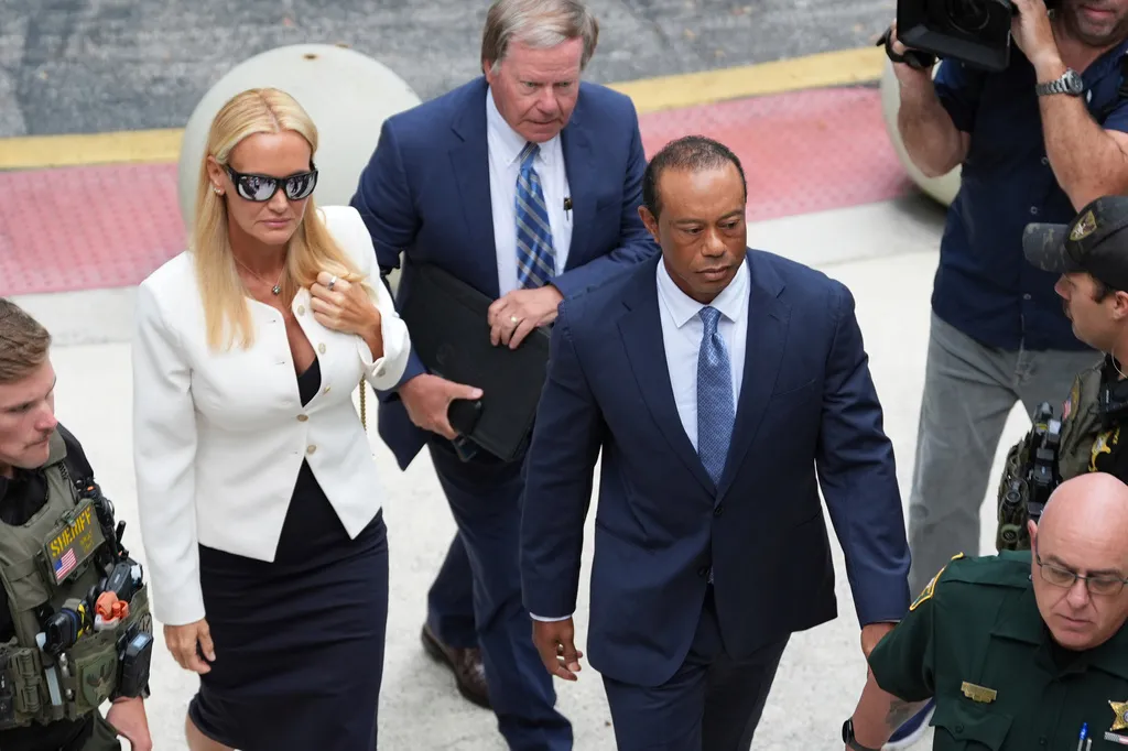 Golfer Tiger Woods, right, with Vanessa Trump, left, arrive for Woods’ plea conference hearing in a DUI case stemming from a rollover crash in Florida in March, Wednesday, Sept. 2, 2026, in Stuart, Florida. (AP Photo/Rebecca Blackwell)