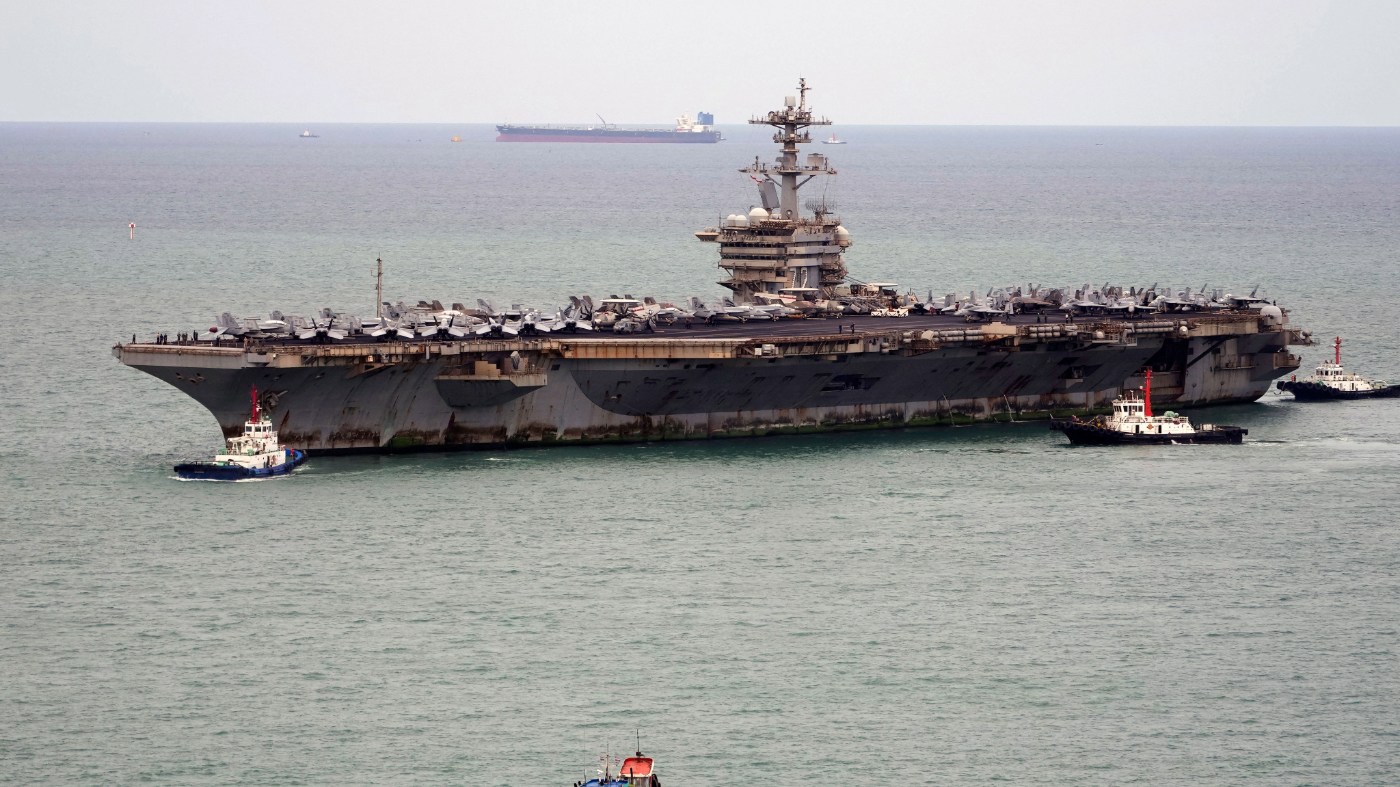 Tug boats greet the U.S. Navy aircraft carrier USS Abraham Lincoln as it arrives at the port in Laem Chabang, Chonburi, Thailand, Sept. 2, 2026.