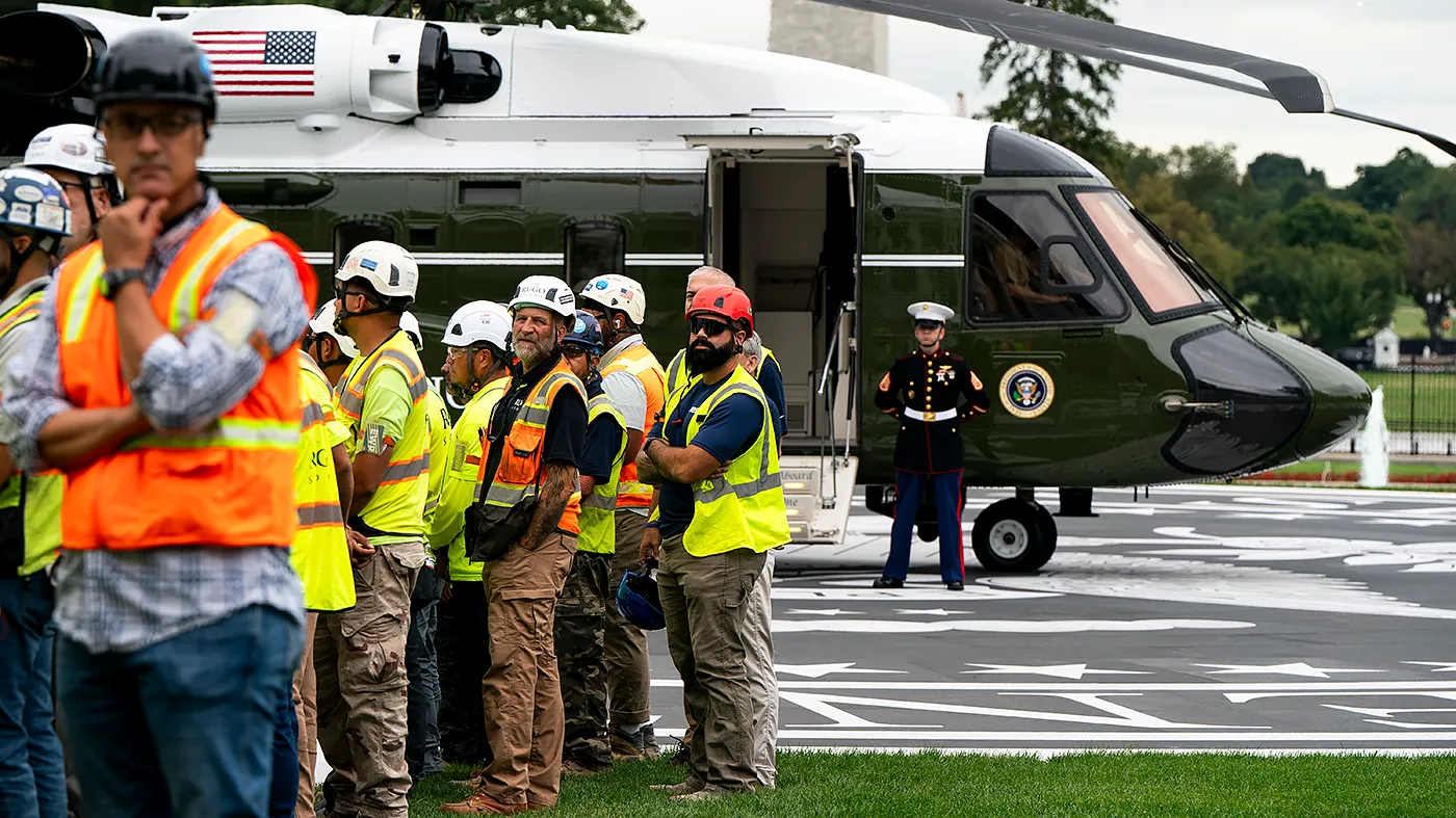 Construction workers are seen before a ribbon cutting ceremony for the new helipad on the South Lawn of the White House in Washington, D.C., on Monday, September 21, 2026.
