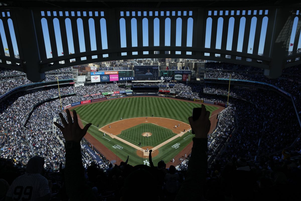 Fans react after New York Yankees’ Aaron Judge hits a home run during the third inning of a baseball game against the San Francisco Giants at Yankee Stadium, April 2, 2023, in New York. (AP Photo/Seth Wenig, File)