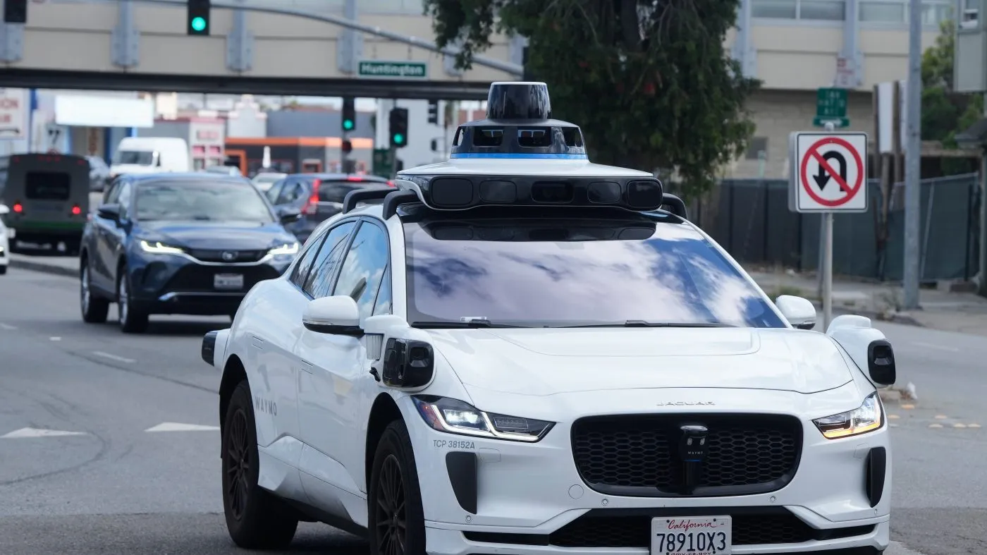 FILE – A Waymo vehicle drives past a No U-Turn sign in San Bruno, Calif., Tuesday, Sept. 30, 2025. (AP Photo/Jeff Chiu, File)