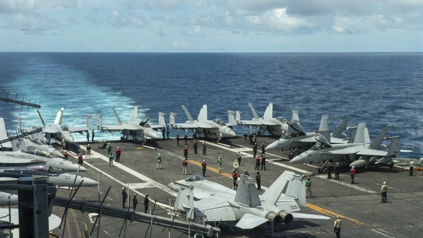 The flight deck of the Nimitz-class aircraft carrier USS Theodore Roosevelt is seen July 4, 2024, in the South China Sea. The Roosevelt is replacing the USS Dwight D. Eisenhower in the Navy’s campaign against attacks by Yemen’s Houthi rebels targeting shipping in the Red Sea corridor over the Israel-Hamas war in the Gaza Strip.