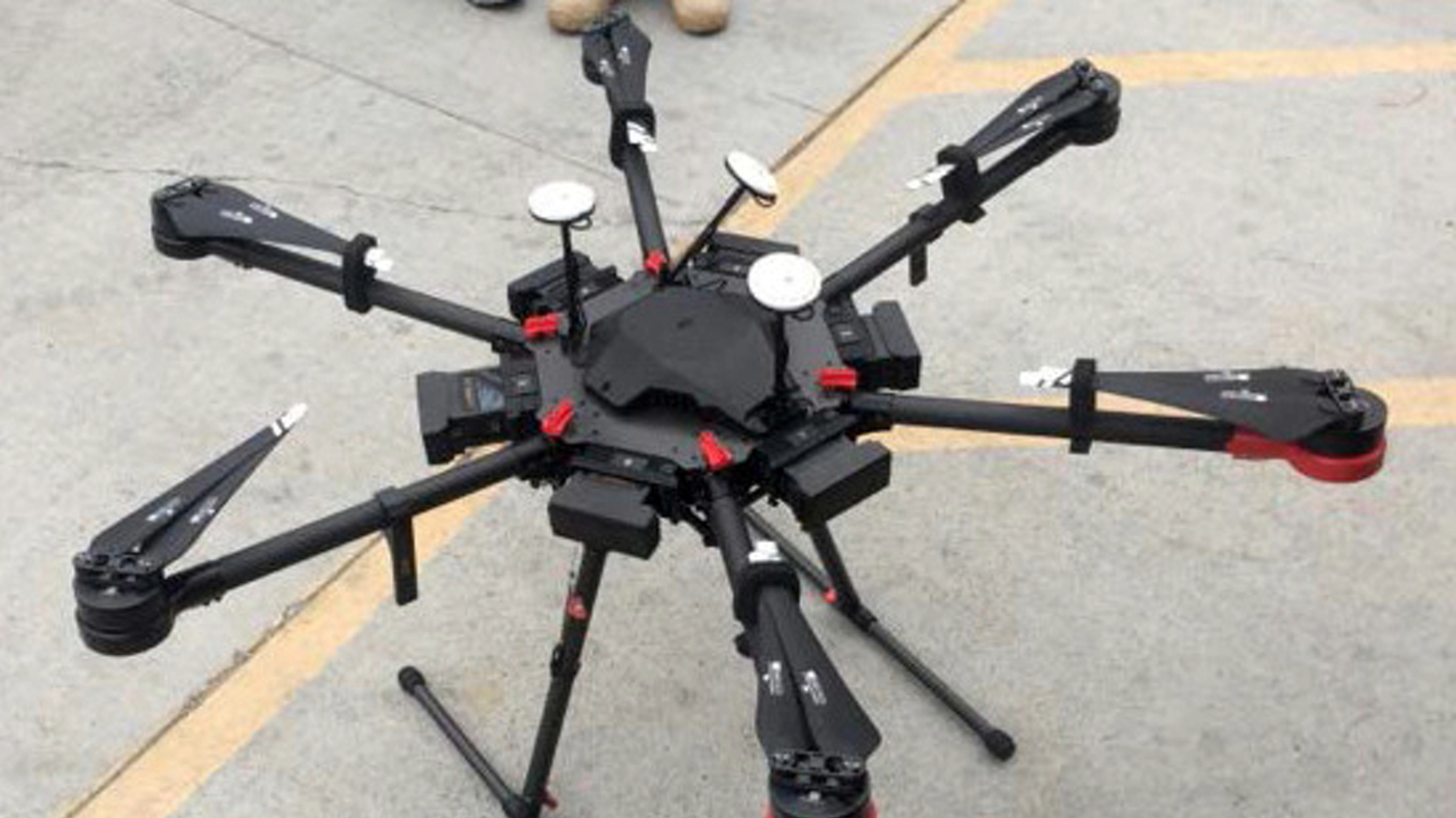 This undated photo provided by the U.S. Border Patrol shows a 2-foot-high drone that a border patrol agent spotted swooping over the border fence on Tuesday, Aug. 8, 2017, near a San Diego border crossing. Authorities have arrested a man they say used the drone to fly drugs across the Mexican border into California. (U.S. Border Patrol via AP)