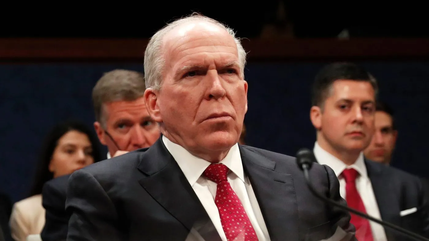 FILE – Former CIA Director John Brennan is reflected in a table as he prepares to testify on Capitol Hill in Washington, Tuesday, May 23, 2017. (AP Photo/Pablo Martinez Monsivais, File)