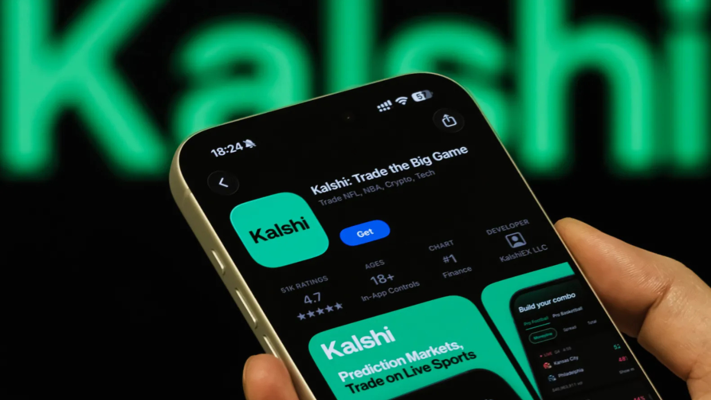A person holds a smartphone displaying the Kalshi app page on the Apple App Store, with the Kalshi branding visible in the background, on Feb. 8, 2026, in Chongqing, China.