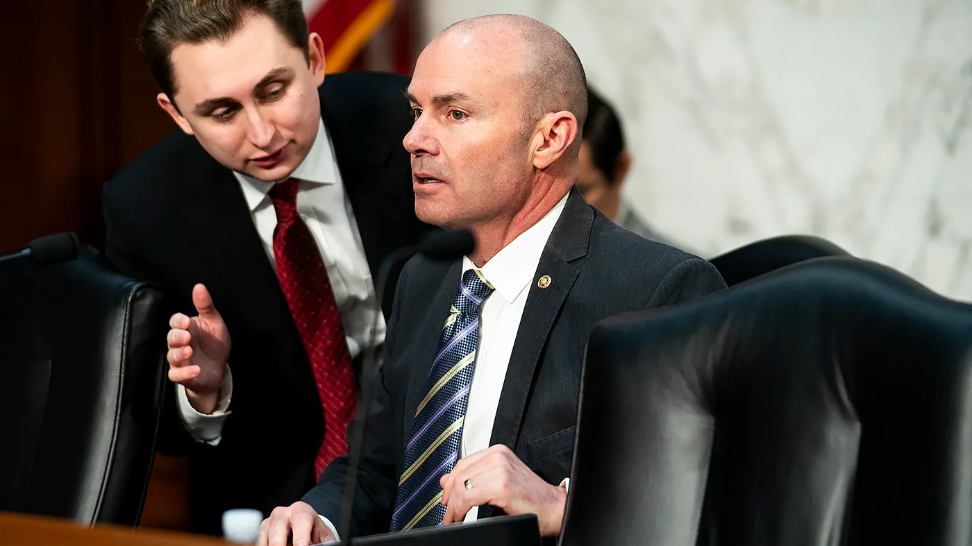 Sen. Mike Lee (R-Utah) speaks to an aide before a Senate Judiciary subcommittee hearing to discuss Operation Arctic Frost on March 24, 2026.