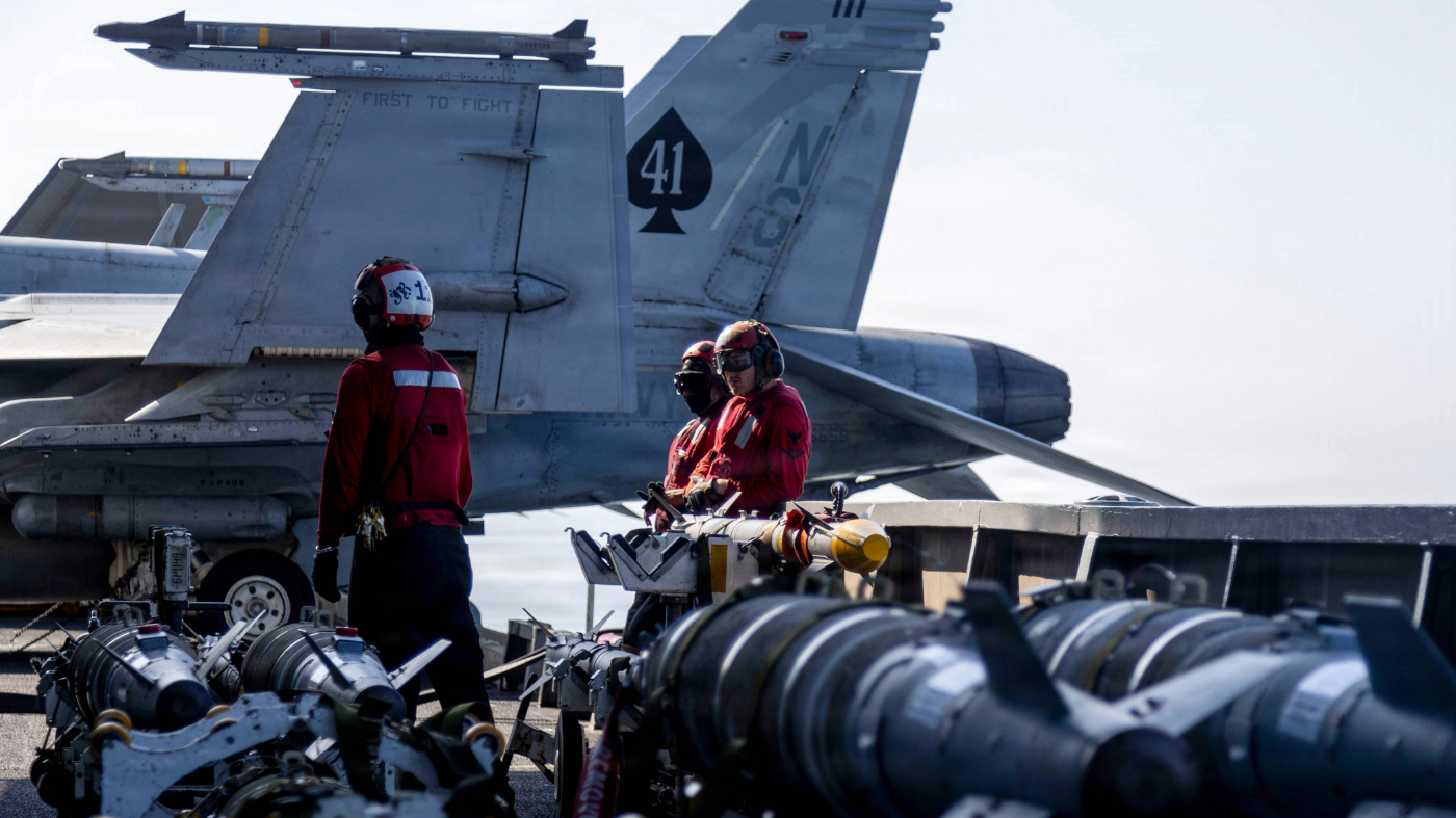This image provided by U.S. Central Command shows Navy sailors looking over ordnance on the flight deck of the USS Abraham Lincoln (CVN 72) in support of Operation Epic Fury on March 2, 2026.