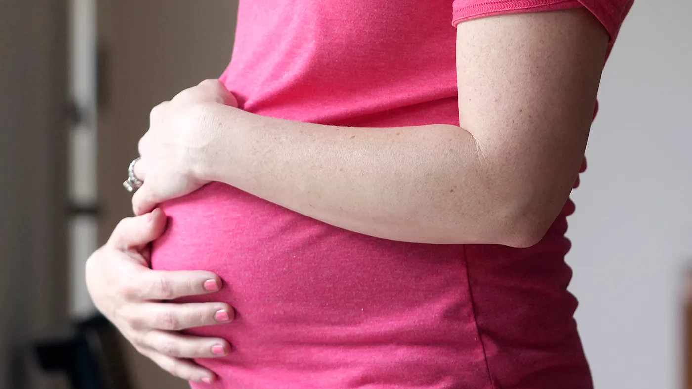 A pregnant woman stands for a portrait in Dallas, May 18, 2023.