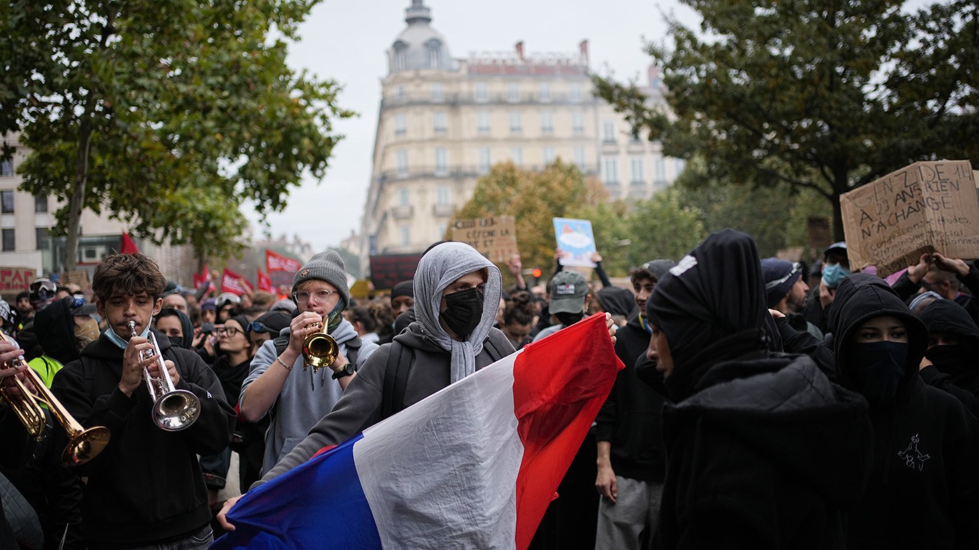 A protesters holds a French flag during a demonstration against rising living costs, joining students’ grievances, in Lyon, France, Saturday, Oct. 17, 2026.