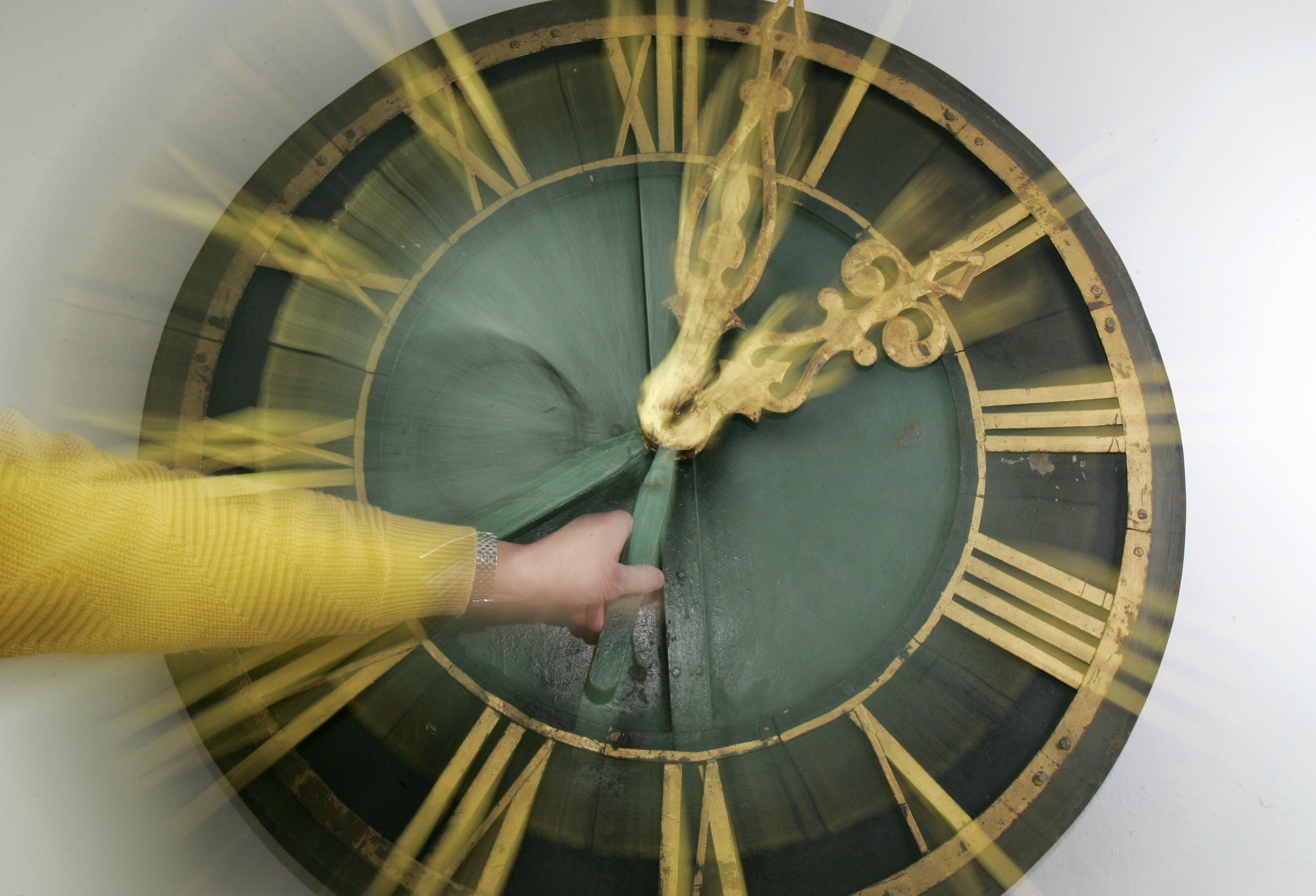 Hans Peter Kuban adjusts the hands on a turret clock face at his turret clock archive in Stuttgart on Thursday, March 23, 2006. The Stuttgart-based collector has gathered dozens of historical turret clocks from across Germany and displays them in a former air-raid shelter. This coming Sunday, March 26, 2006, at 2:00 a.m., the time will be set forward by one hour, marking the start of daylight saving time. (AP Photo/Thomas Kienzle)