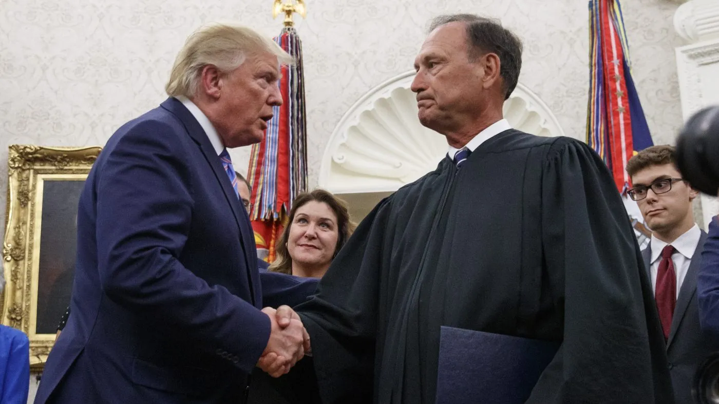 President Trump shakes hands with Supreme Court Justice Samuel Alito after Mark Esper was sworn in as Secretary of Defense during a ceremony in the Oval Office at the White House in Washington on July 23, 2019.
