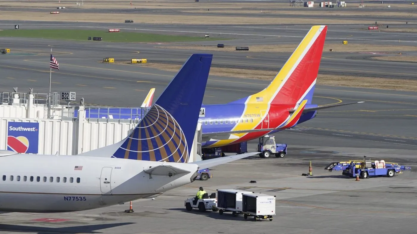 Passenger jets rest on the tarmac at Logan International Airport, Jan. 11, 2023, in Boston.