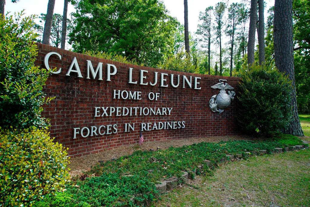 FILE – Signage stands on the main gate to Camp Lejeune Marine Base outside Jacksonville, N.C., April 29, 2022. Military personnel stationed at Camp Lejeune from 1975 to 1985 had at least a 20% higher risk for a number of cancers than those stationed elsewhere, federal health officials said Wednesday, Jan. 31, 2024 in a long-awaited study of the North Carolina base’s contaminated drinking water. (AP Photo/Allen G. Breed, File)