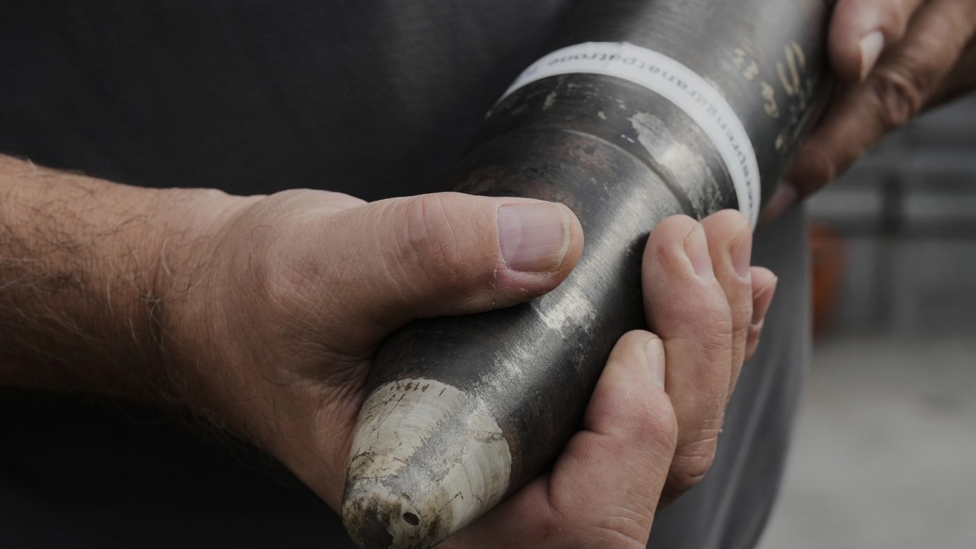 A man of an ammunition recovery service shows a 78 millimetre artillery grenade as an example during a press tour to show the recovering of ammunition from World War II in the Baltic Sea, in Boltenhagen, Germany, Monday, Sept. 1, 2025. (AP Photo/Markus Schreiber)