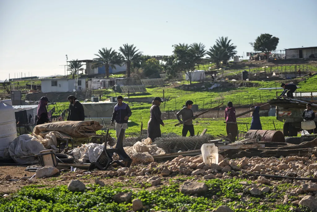 Palestinian residents of Ras Ein al-Auja village, West Bank pack up their belongings and prepare to leave their homes after deciding to flee mounting settler violence, Sunday, Jan. 11, 2026. (AP Photo/Mahmoud Illean)