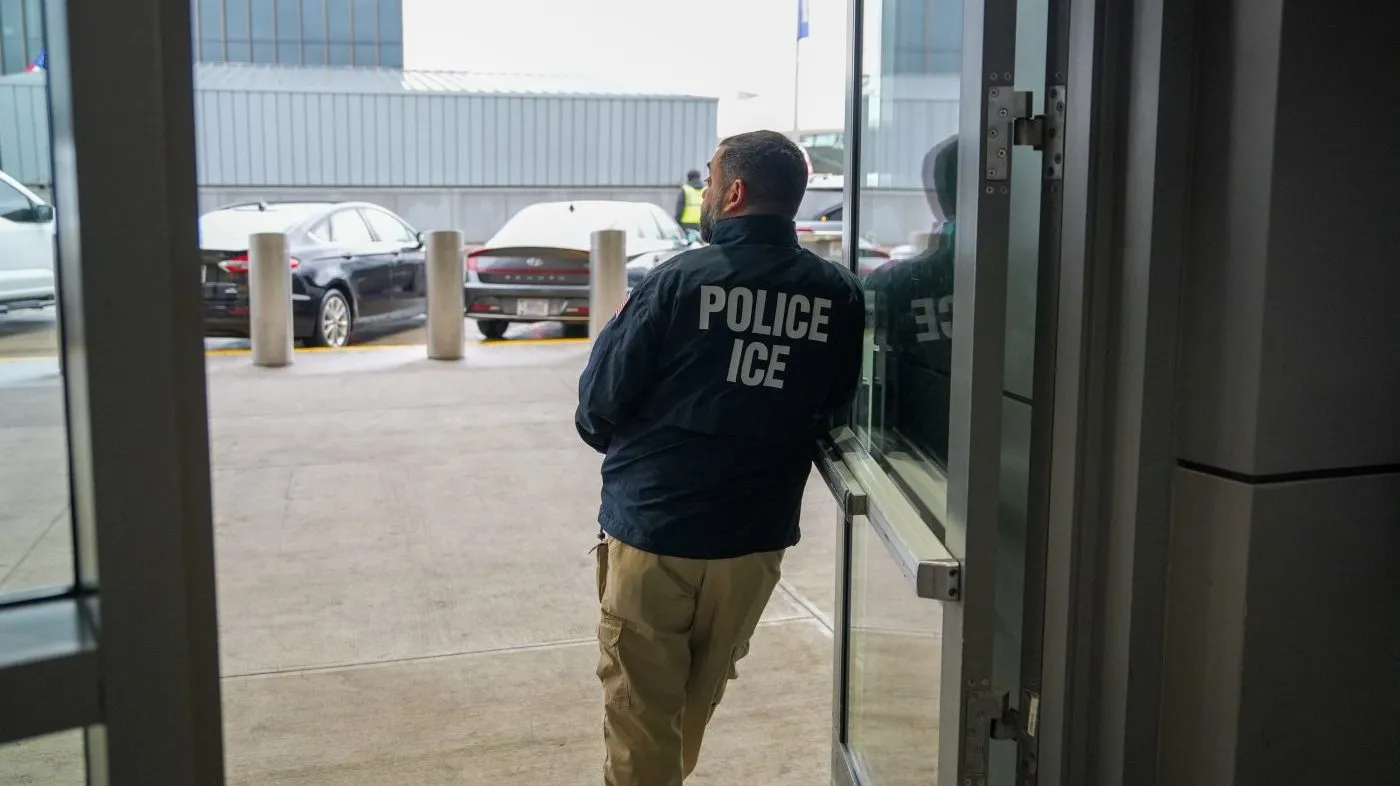 A U.S. Immigration and Customs Enforcement (ICE) agent stands at John F. Kennedy International Airport (JFK) in the Queens borough of New York, Monday, March 23, 2026.