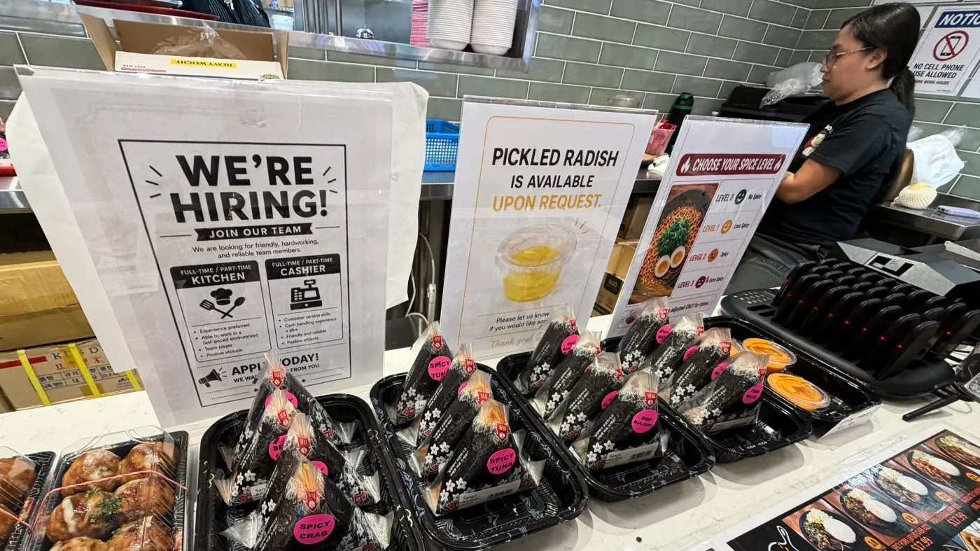 A hiring sign is displayed at a food court in a grocery store, in Schaumburg, Ill., Sept. 16, 2026.